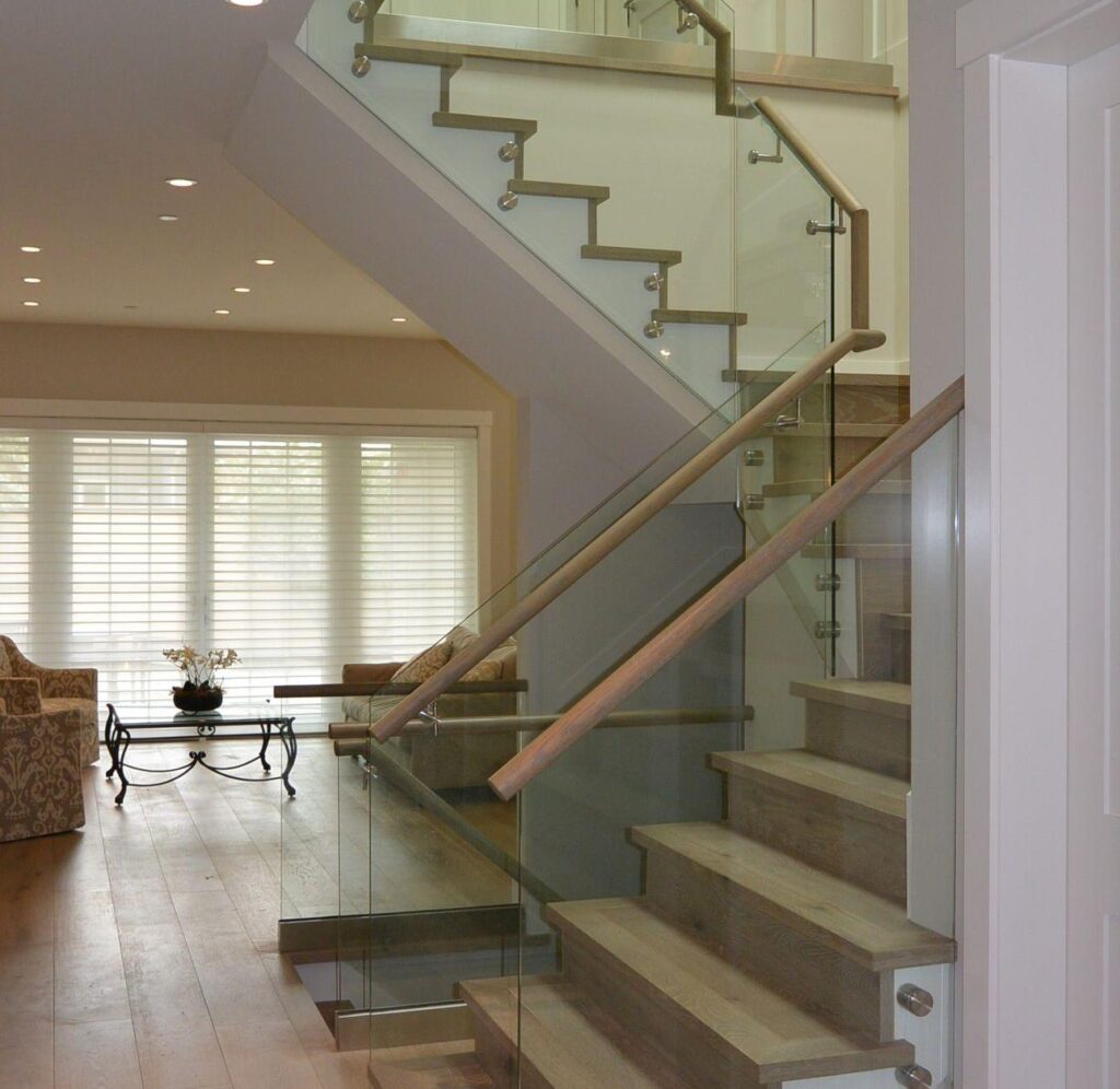 indoor glass railing installed for stairs inside of the house