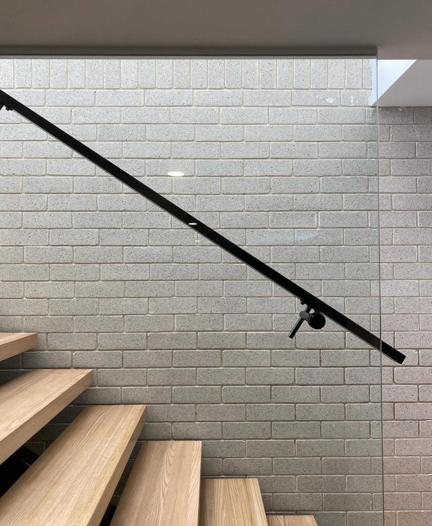 Glass stair railing shown for measurement requirements of stairs

