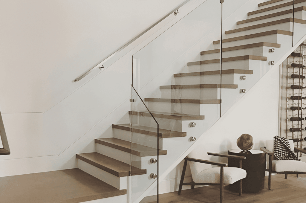 Modern interior staircase with frameless glass railing hardware and stainless steel standoffs