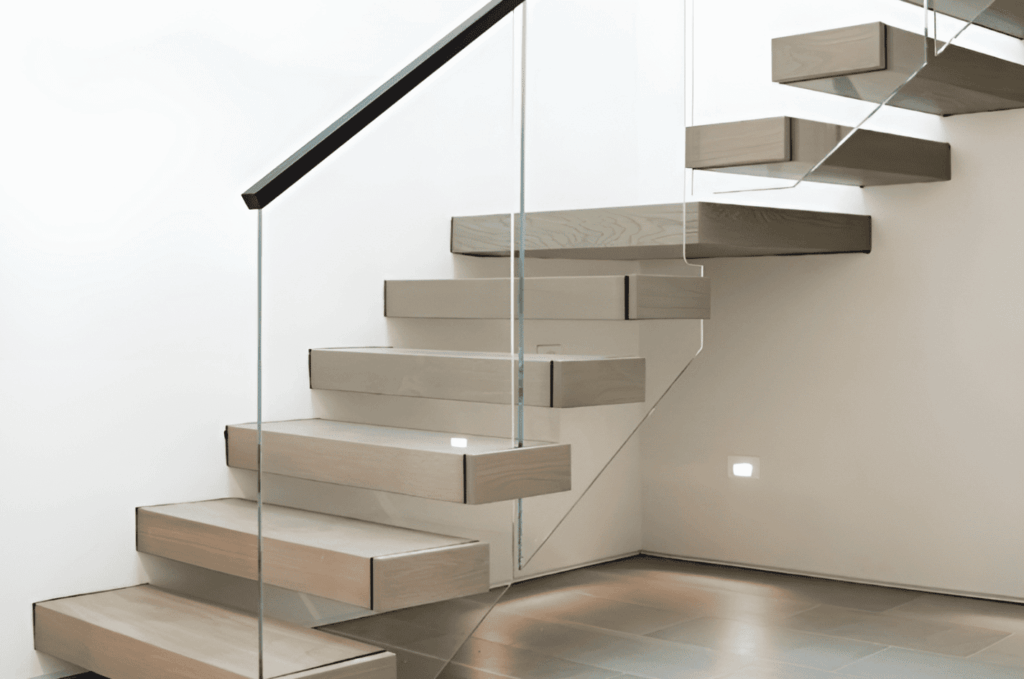 Frameless basement stairs glass railing creating a clean, open look with floating wooden steps