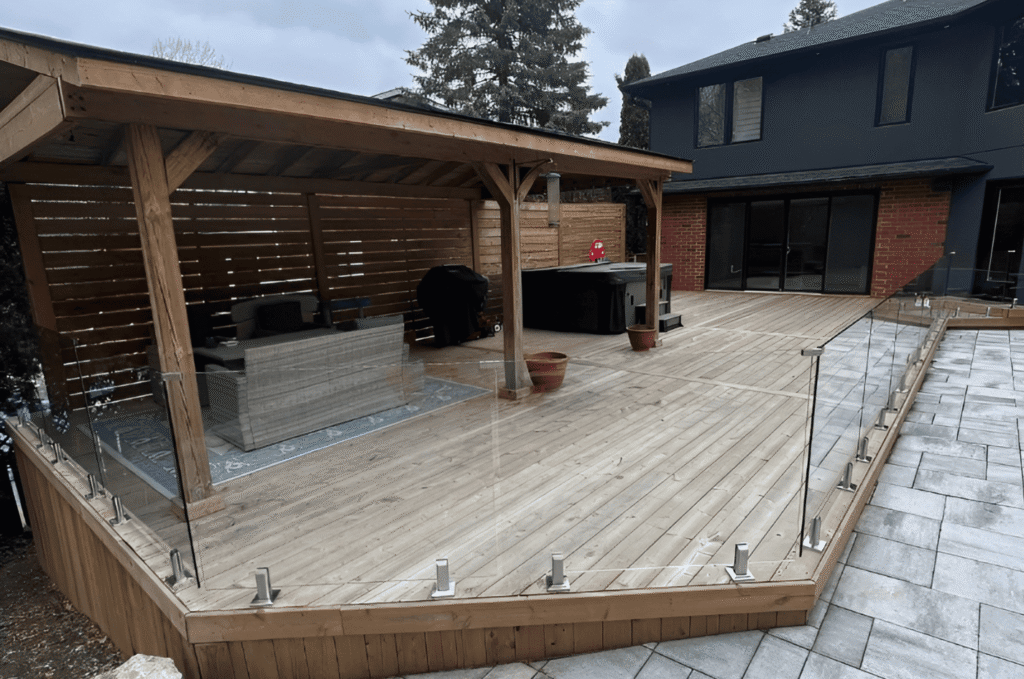 home exterior deck design showcasing frameless glass railing installation with outside view