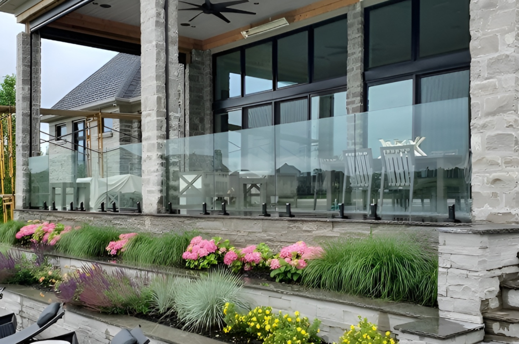 Contemporary building with commercial glass balcony railing enclosing a spacious patio seating area