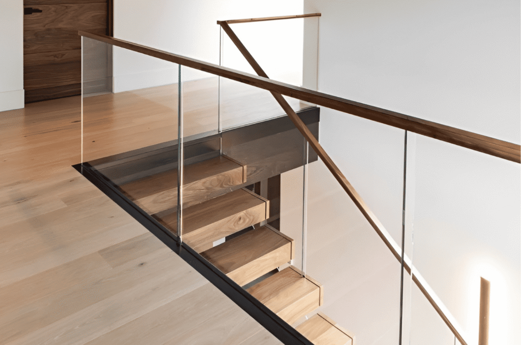 Wood stairs with safety glass railing to prevent child and pet falls while maintaining open visual flow