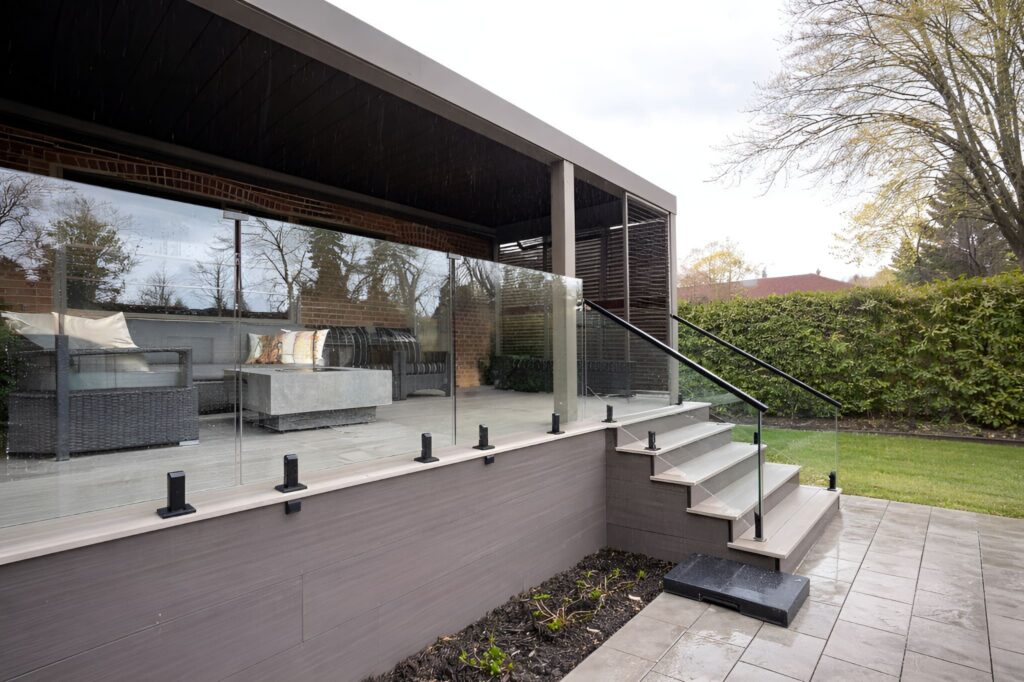 Outdoor glass railing with rain protection, creating clear views during wet weather