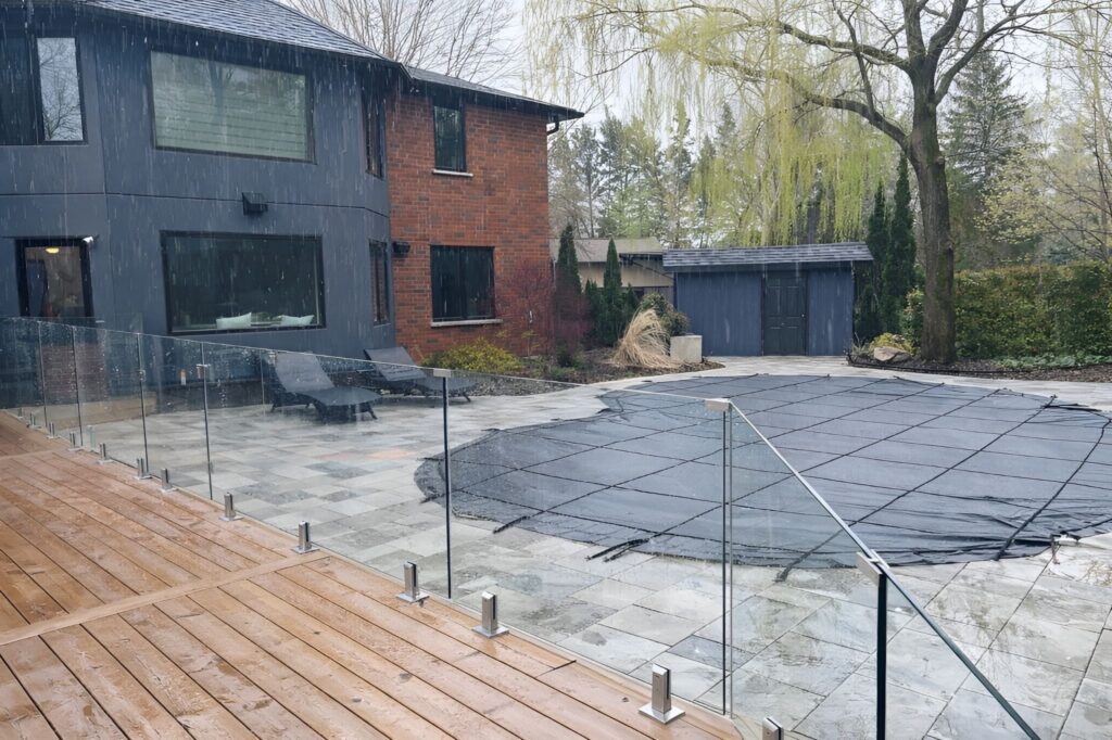 Outdoor glass railing in rainy conditions, adding rain care, safety, and modern protection around deck and pool