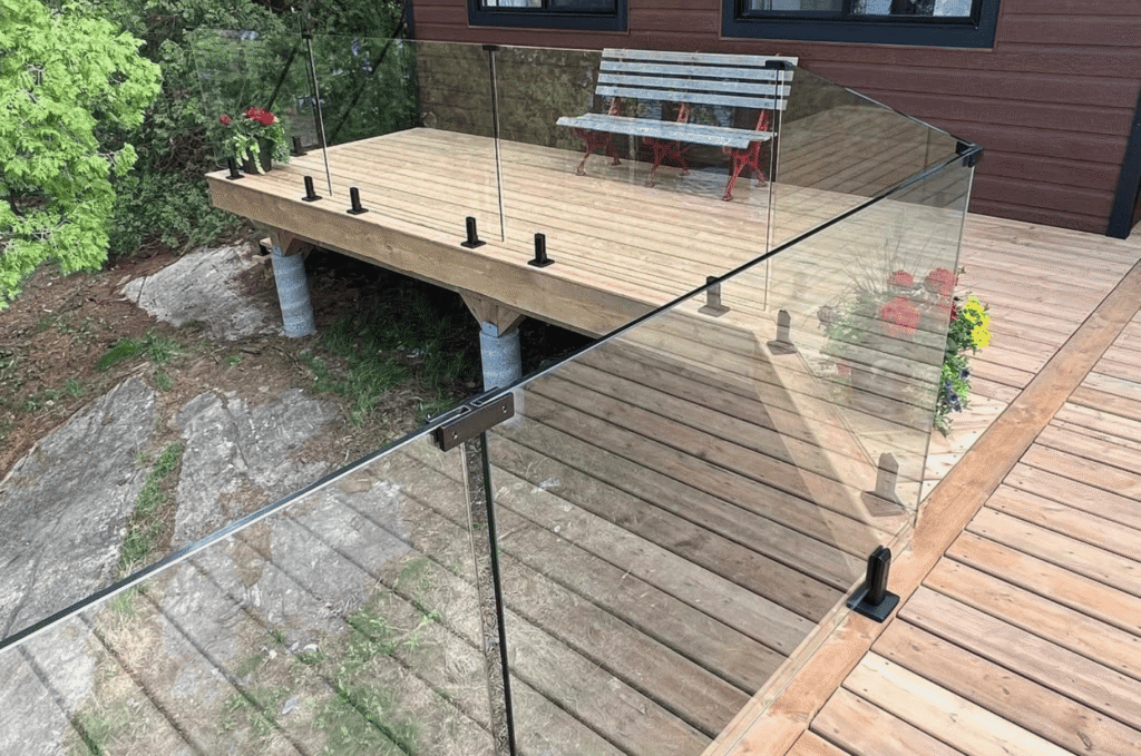 Outdoor deck secured with modern glass railing systems with clear views maintaining safety and a modern finish