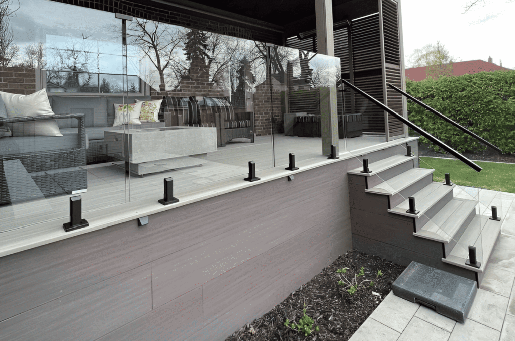 Floating wood stairs with frameless glass railing and stainless handrail in a contemporary home interior