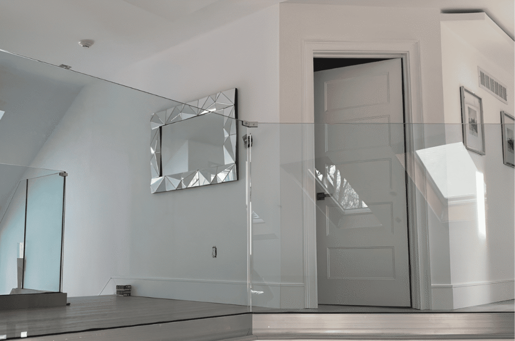 Modern indoor landing with glass railing systems, creating a clean, open look with safe and durable glass panels