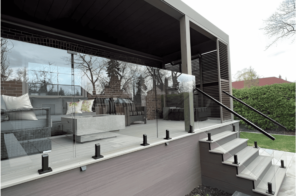 Outdoor glass railing around a covered patio, designed to improve glass railing safety while keeping clear view
