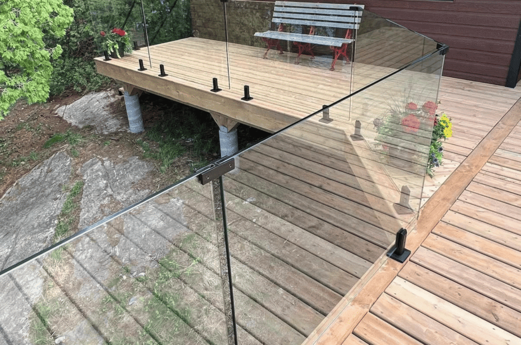 Outdoor glass railing installed on a raised wooden deck, improving glass railing safety without blocking the view