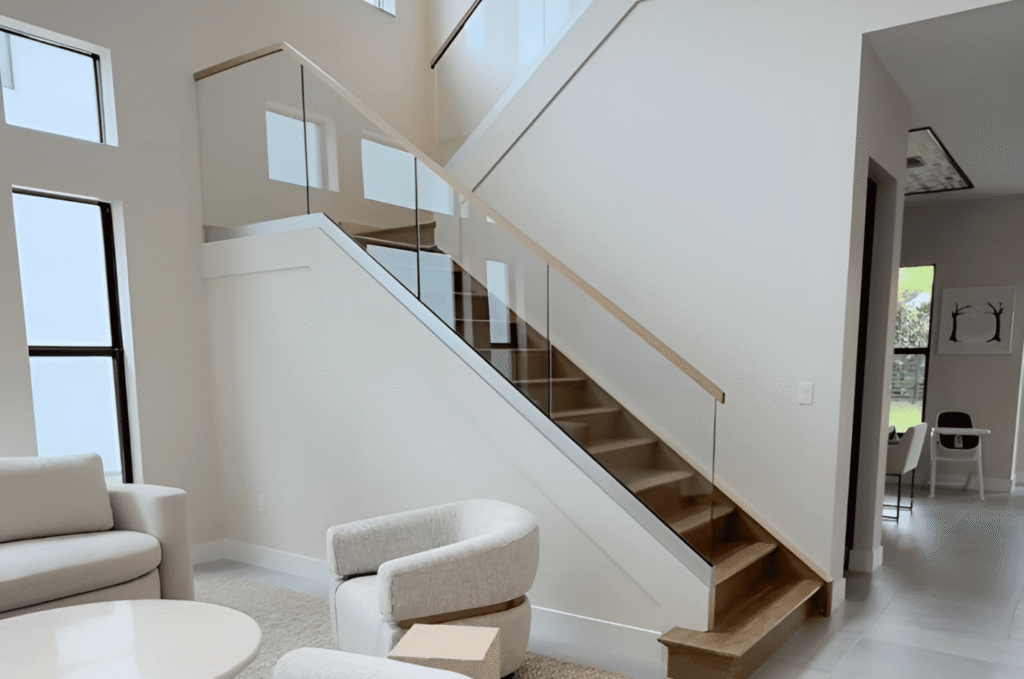 Professional glass railing contractor measuring a balcony installation for a Seattle home 