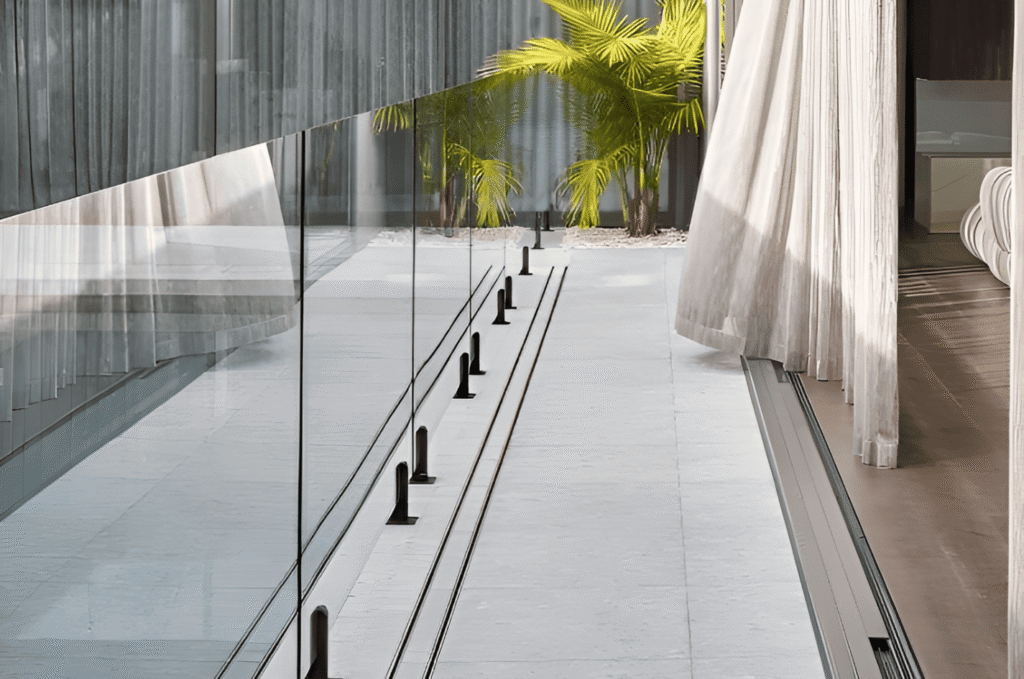 Custom glass railing installation showing frameless and framed system options for a residential staircase and deck project 