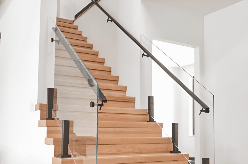 Modern glass stair railing with wood steps, black handrail, clear panels, and key final walkthrough inspection details inside