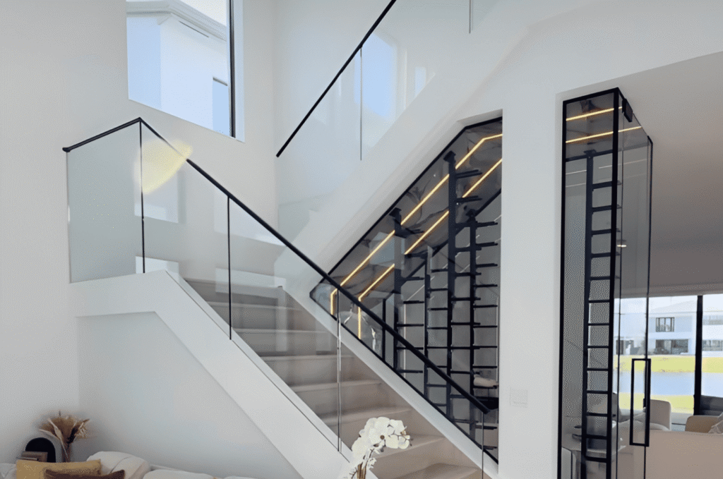 Indoor glass railing panels with black handrail and clear safety glass for replacement inspection and safe repair checks