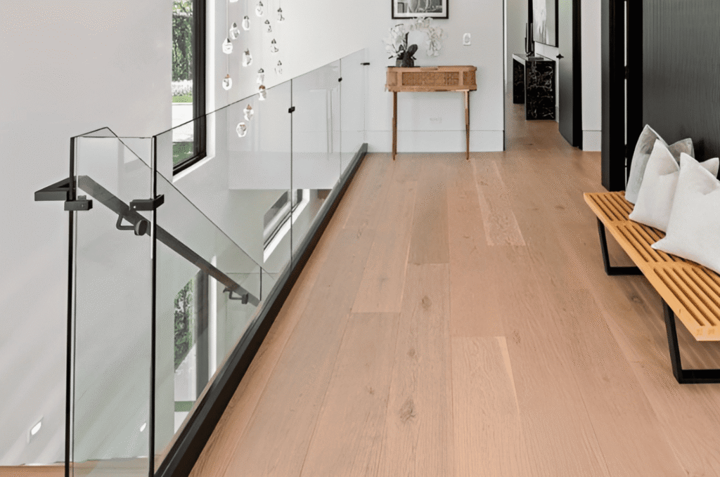 Frameless tempered glass railing panels set in a base shoe along an indoor landing in a modern Seattle-area home